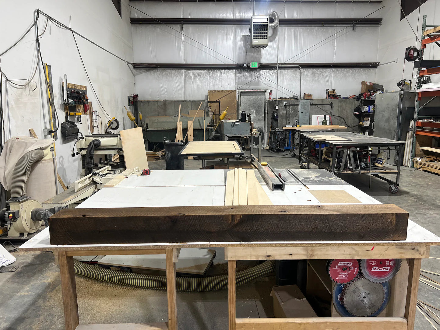 Floating wood beam fireplace mantel or wood floating shelf in the workshop.