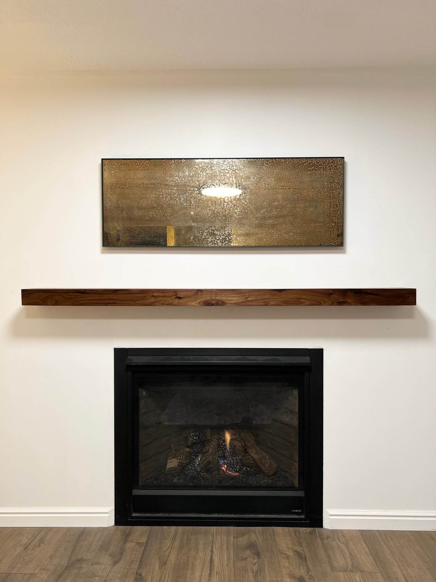 Front view of the installed floating wood beam or wood box fireplace mantel. The fireplace mantel has a smooth finish and a modern look.