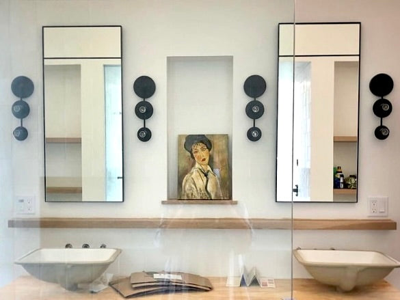Two custom, handmade steel framed inlaid mirrors in a contemporary bathroom over a double vanity with eclectic decor.