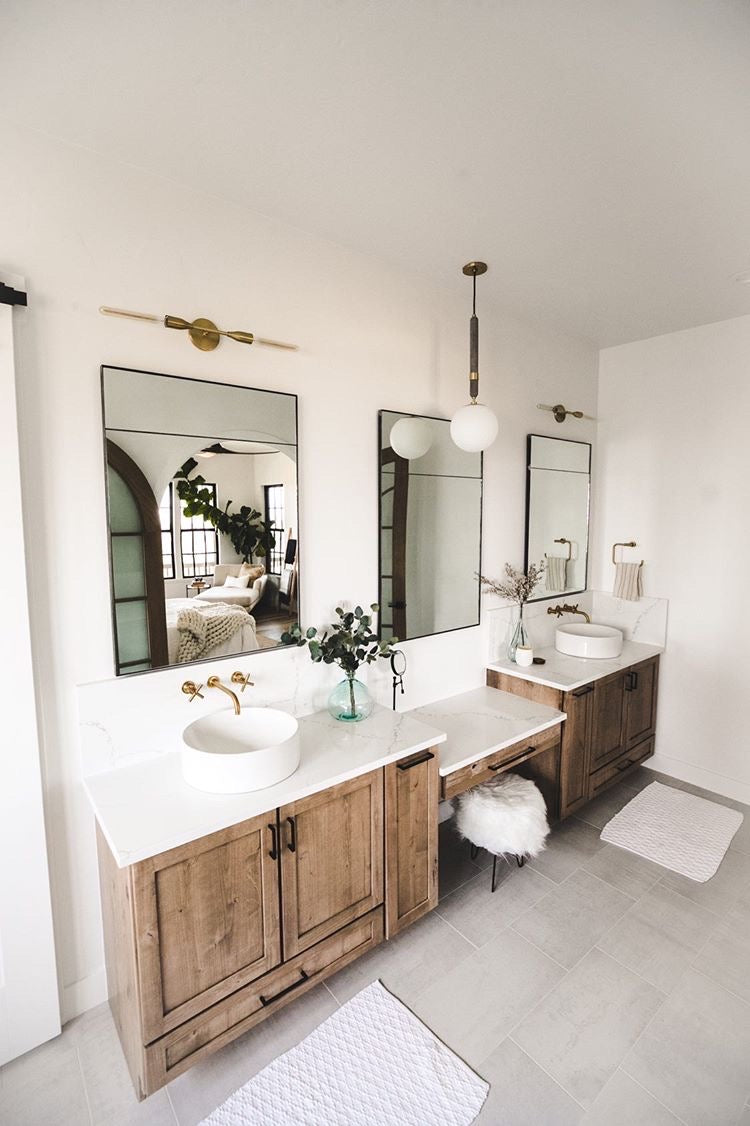 Three steel framed Custom Inlaid Mirrors wall mounted over a large double vanity with white and wood accents in the bathroom.